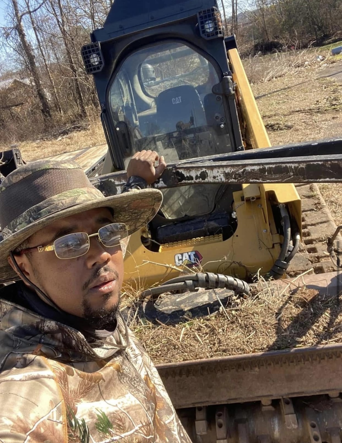 Gerald with a CAT skid steer on the job